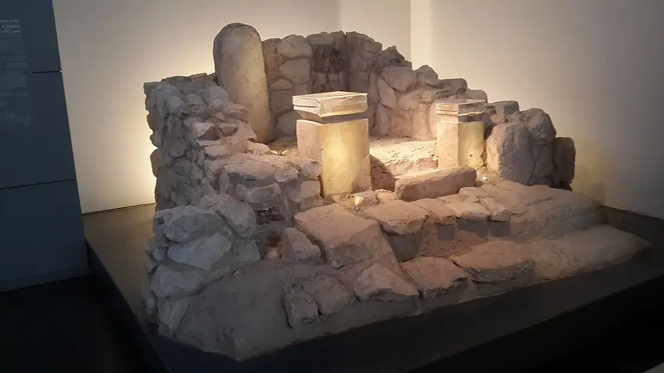 The reconstructed inner shrine of the Judahite sanctuary at Arad in the Israel Museum: two limestone incense altars on the steps and a standing stone in the niche behind
