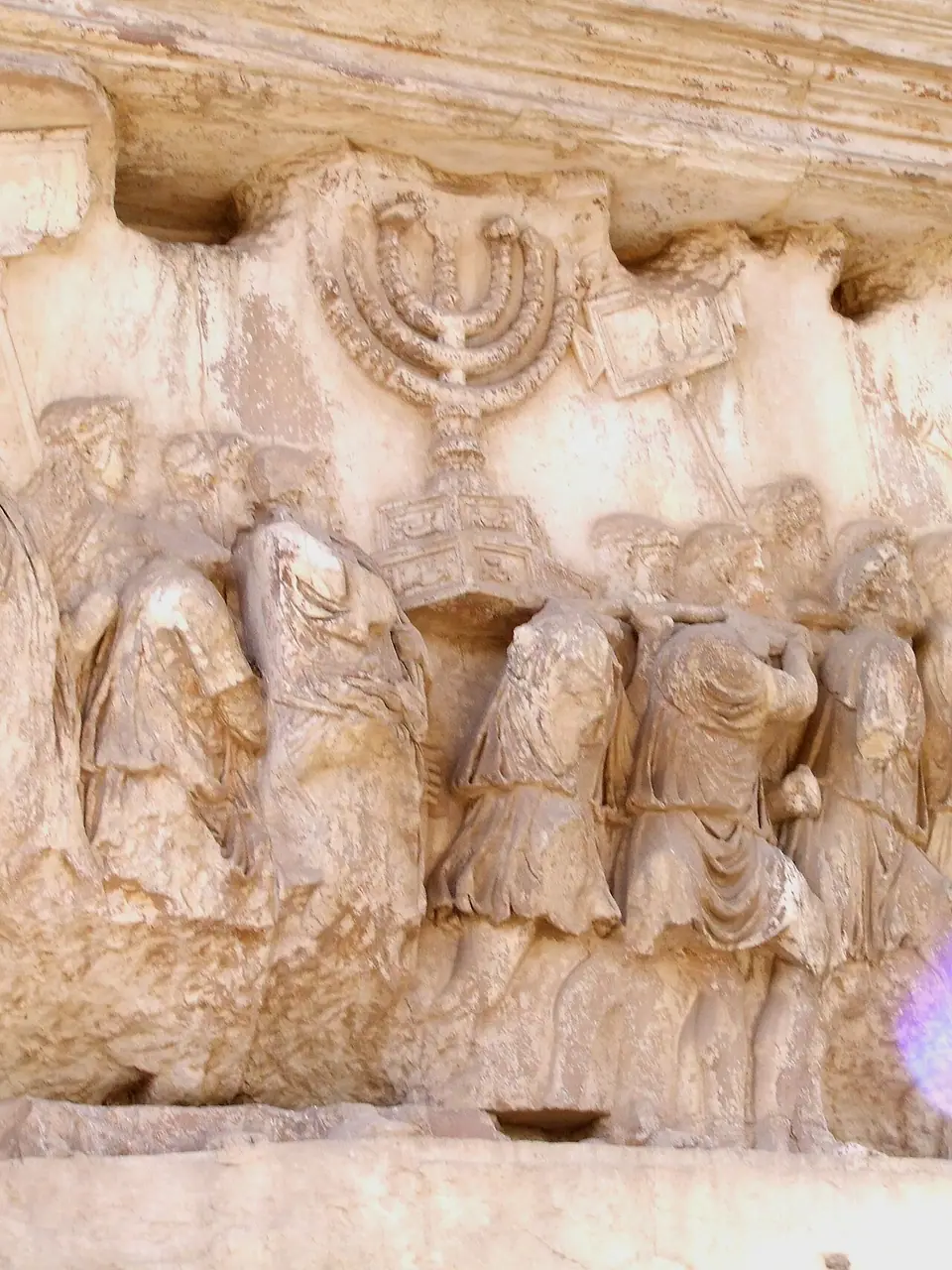 Marble relief on the Arch of Titus showing Roman soldiers carrying the seven-branched menorah and other spoils from the Temple in Jerusalem