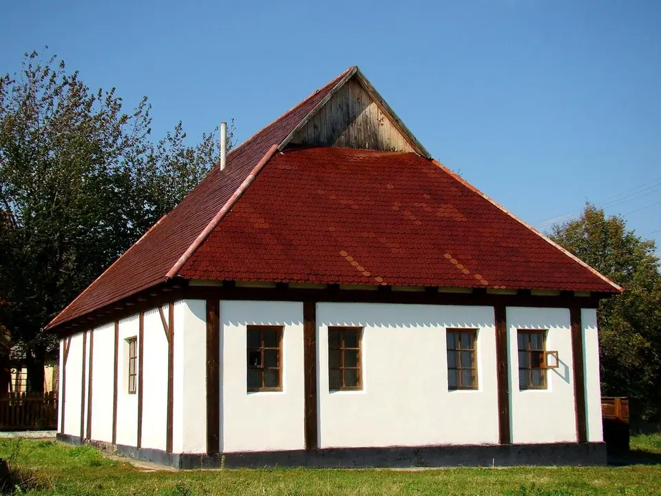 The reconstructed wooden synagogue of the Baal Shem Tov in Medzhybizh, Ukraine, a low timber building with a shingled roof, photographed in 2010