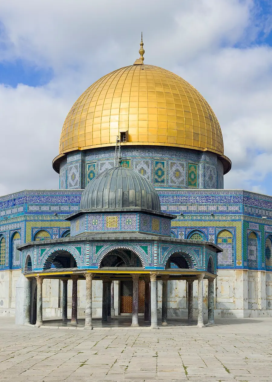 The Dome of the Rock in Jerusalem, an octagonal building faced with blue tiles under a gilded dome, with the small Dome of the Chain in front