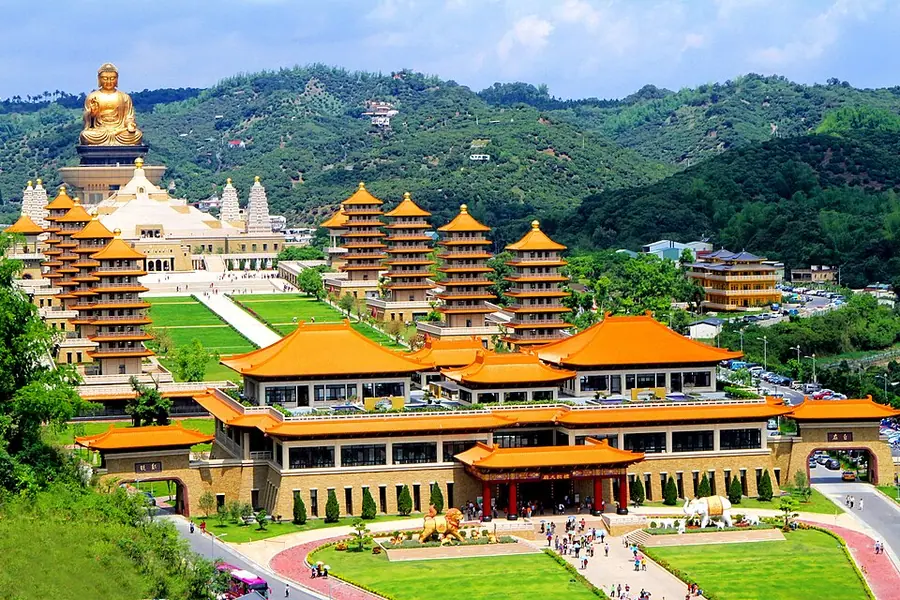 The Fo Guang Shan Buddha Museum in Kaohsiung, Taiwan: a giant gilded seated Buddha on a hill above rows of orange-roofed pagodas and halls