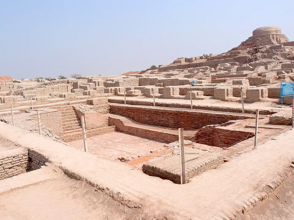 The Great Bath at Mohenjo-daro, a sunken brick tank with steps, with the later Buddhist stupa mound in the background