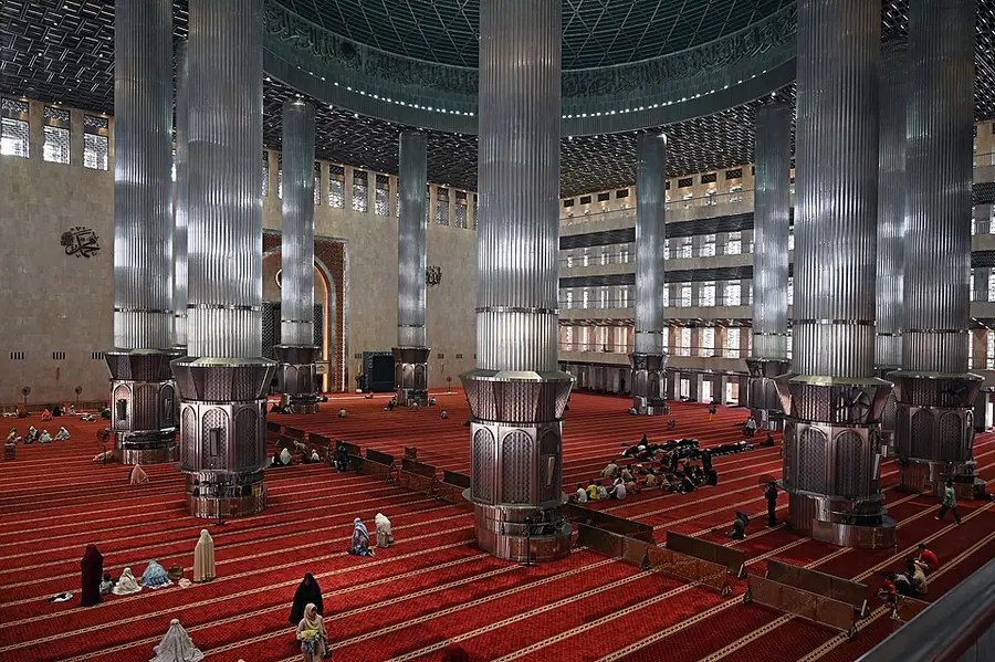The prayer hall of the Istiqlal Mosque in Jakarta, with steel-clad columns and red carpets