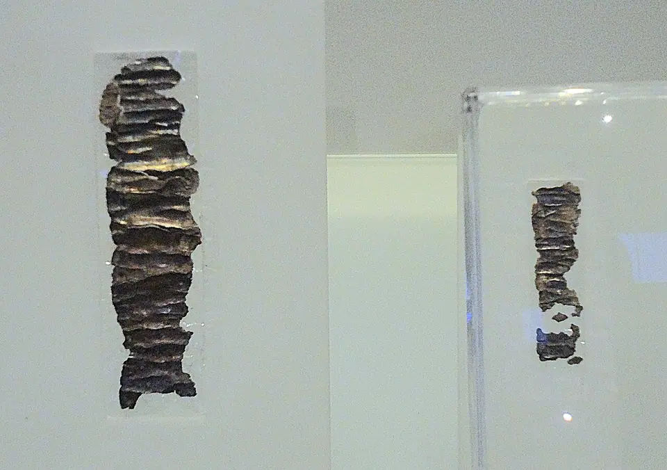 Two small unrolled silver amulets from Ketef Hinnom with faint scratched Hebrew letters