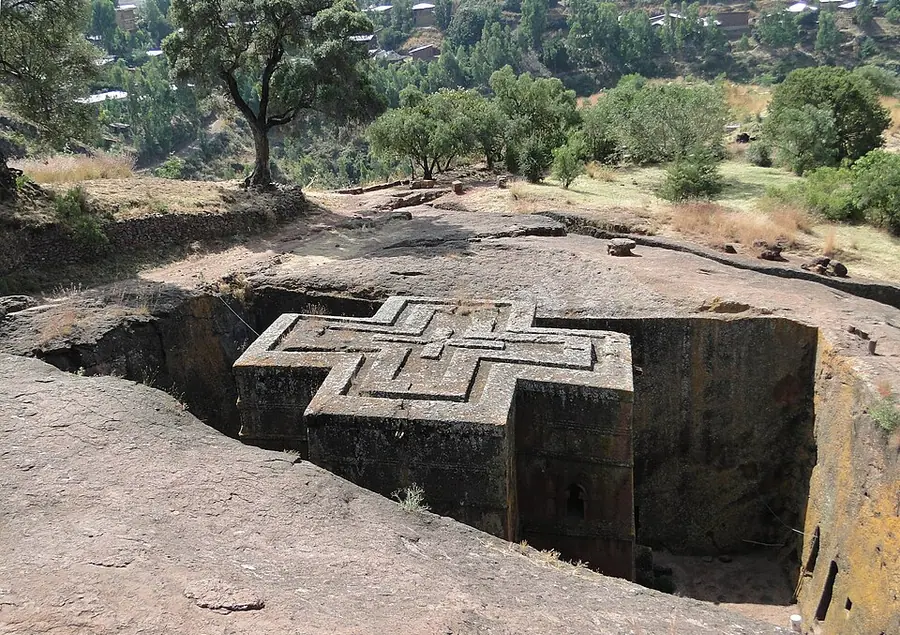 Bete Giyorgis at Lalibela seen from above: a cross-shaped church roof carved out of a pit in reddish rock