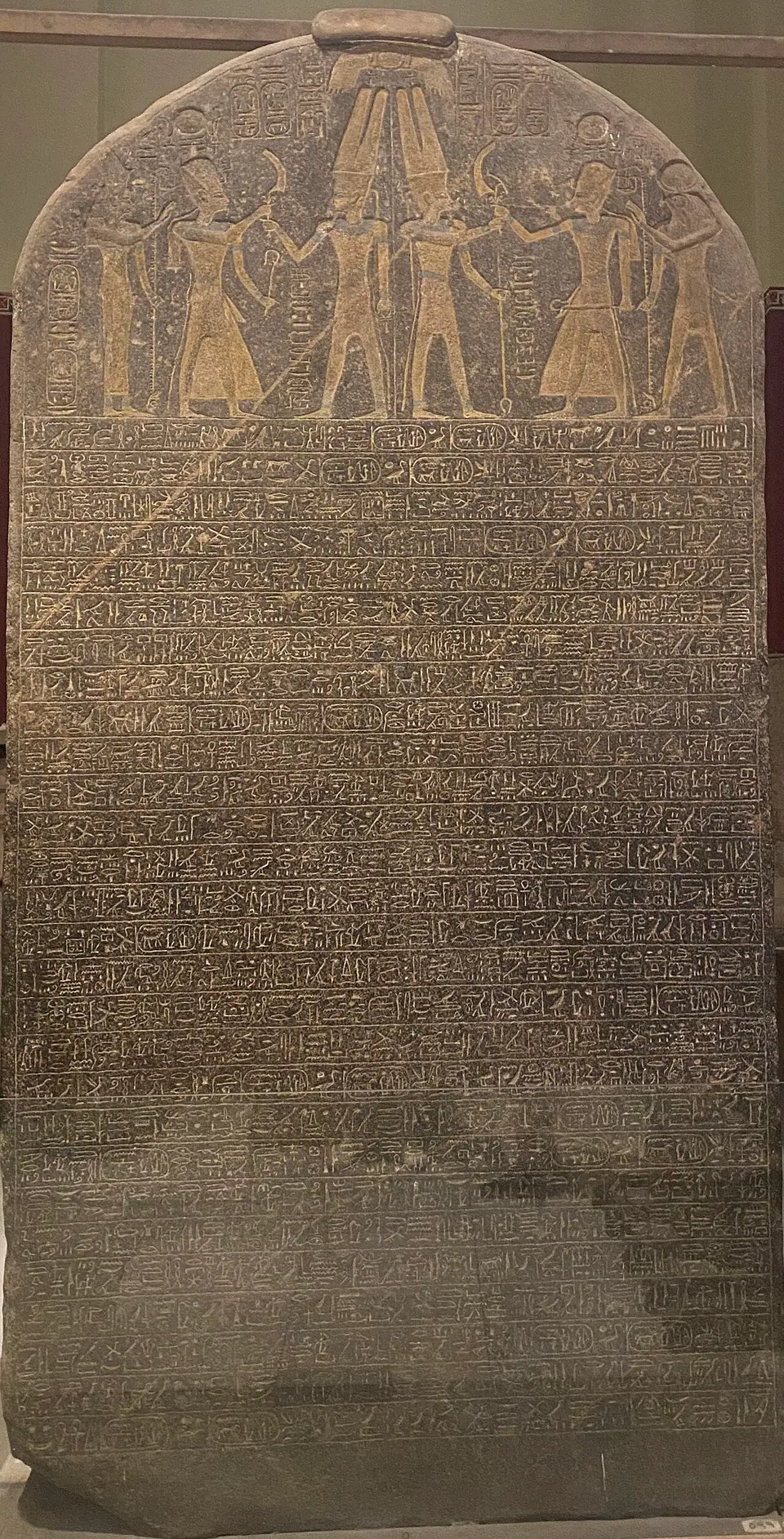 The tall granite Merneptah Stele, its upper part carved with a scene of the pharaoh before the gods and the rest covered in hieroglyphs