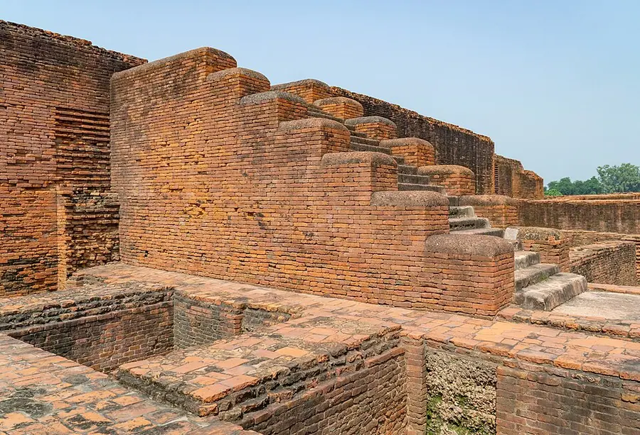 Brick walls, a stair and paved courtyard of Monastery 5 at Nālandā
