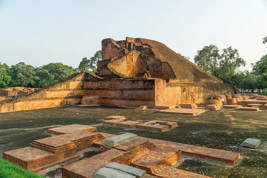 The stepped brick mass of Temple 3 at Nālandā, the site's largest monument, rising above the bases of small votive stupas