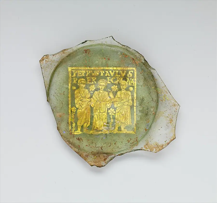 A broken gold-glass plate base showing a woman named Peregrina between Peter and Paul, with their Latin names in gold