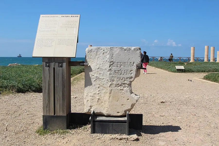 A replica of the Pilate Stone at Caesarea Maritima: a weathered limestone block with three lines of Latin naming Pontius Pilate