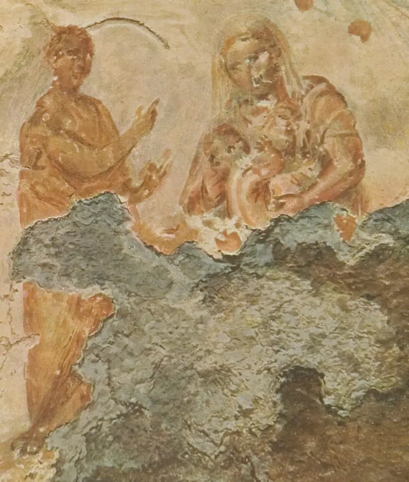 A faded catacomb wall painting of a woman holding a child, with a man beside them pointing upwards towards a star