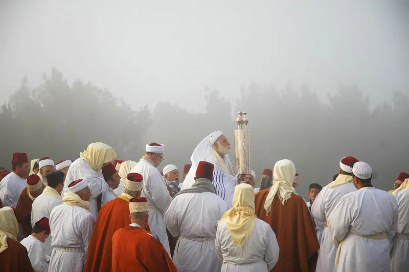 Samaritan men in white clothing gathered on Mount Gerizim for the Passover sacrifice