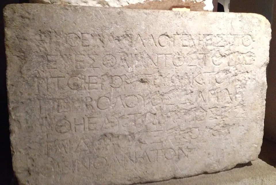 A limestone block carved with seven lines of Greek capitals, the warning to foreigners from the barrier of Herod's Temple
