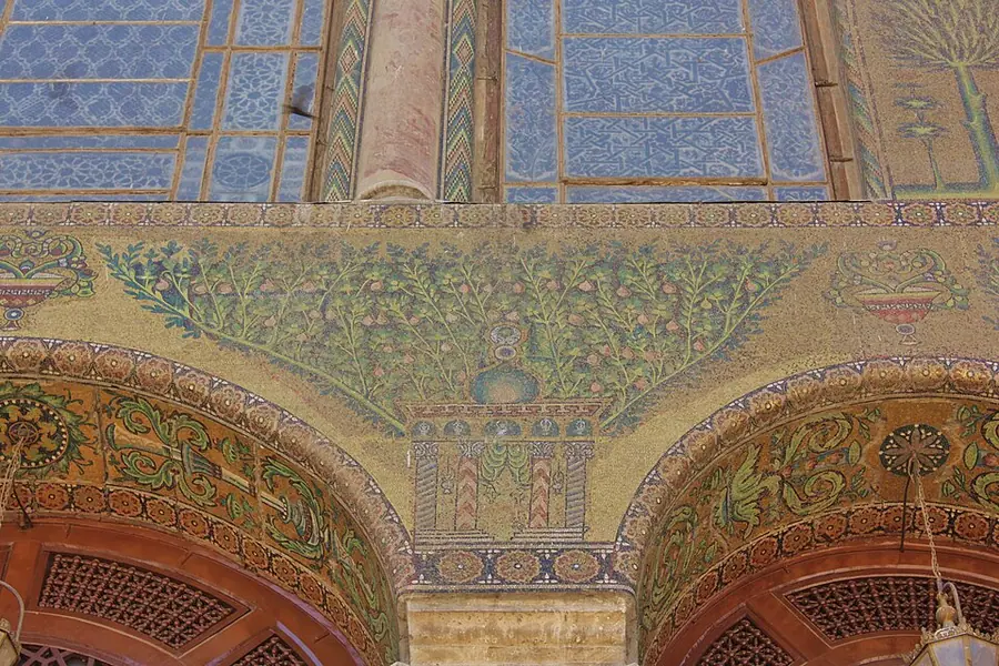Eighth-century gold and green mosaics of trees and buildings on arches in the Umayyad Mosque of Damascus