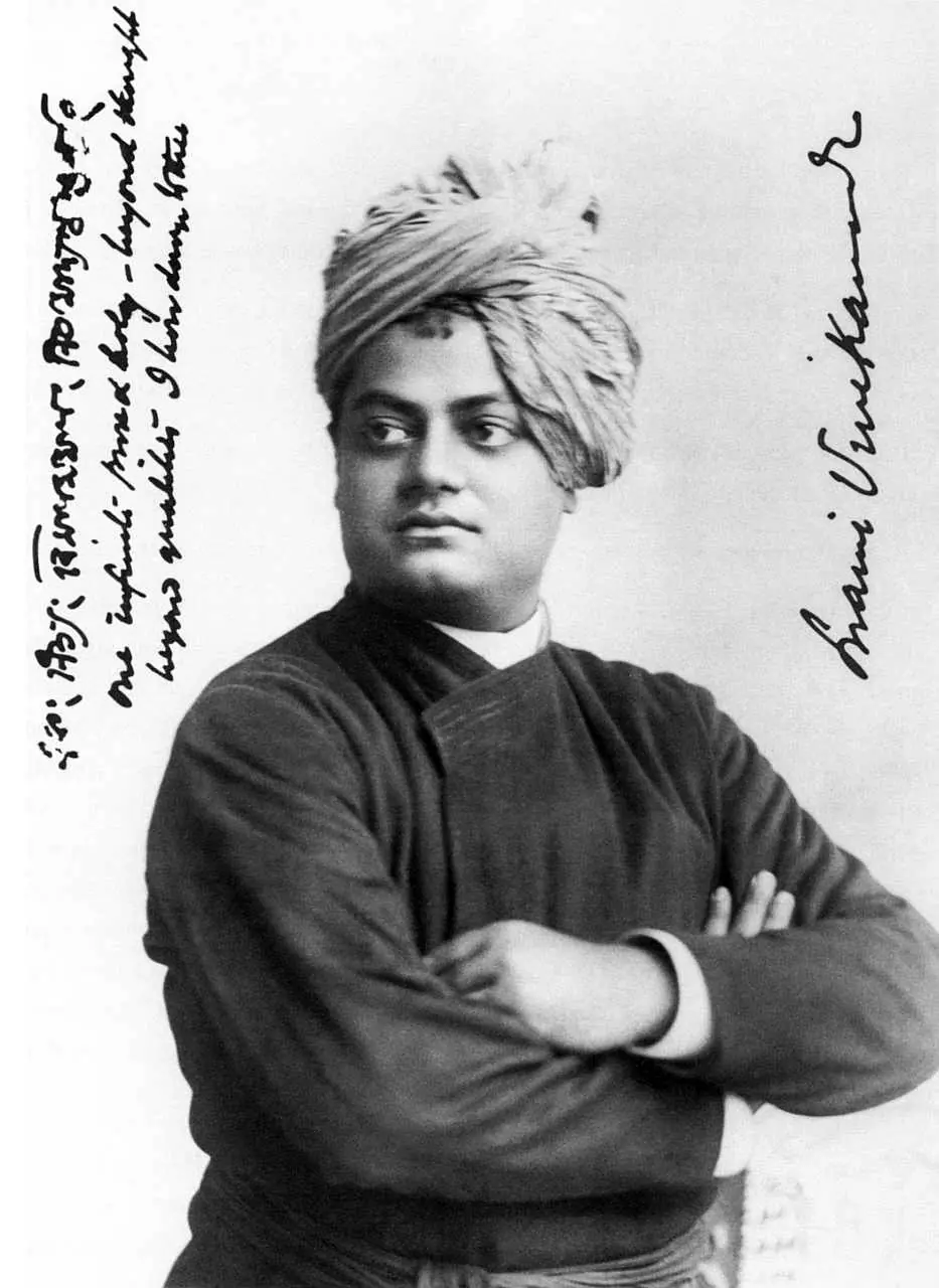Swami Vivekananda in a turban with arms folded, beside his handwritten note and signature, 1893